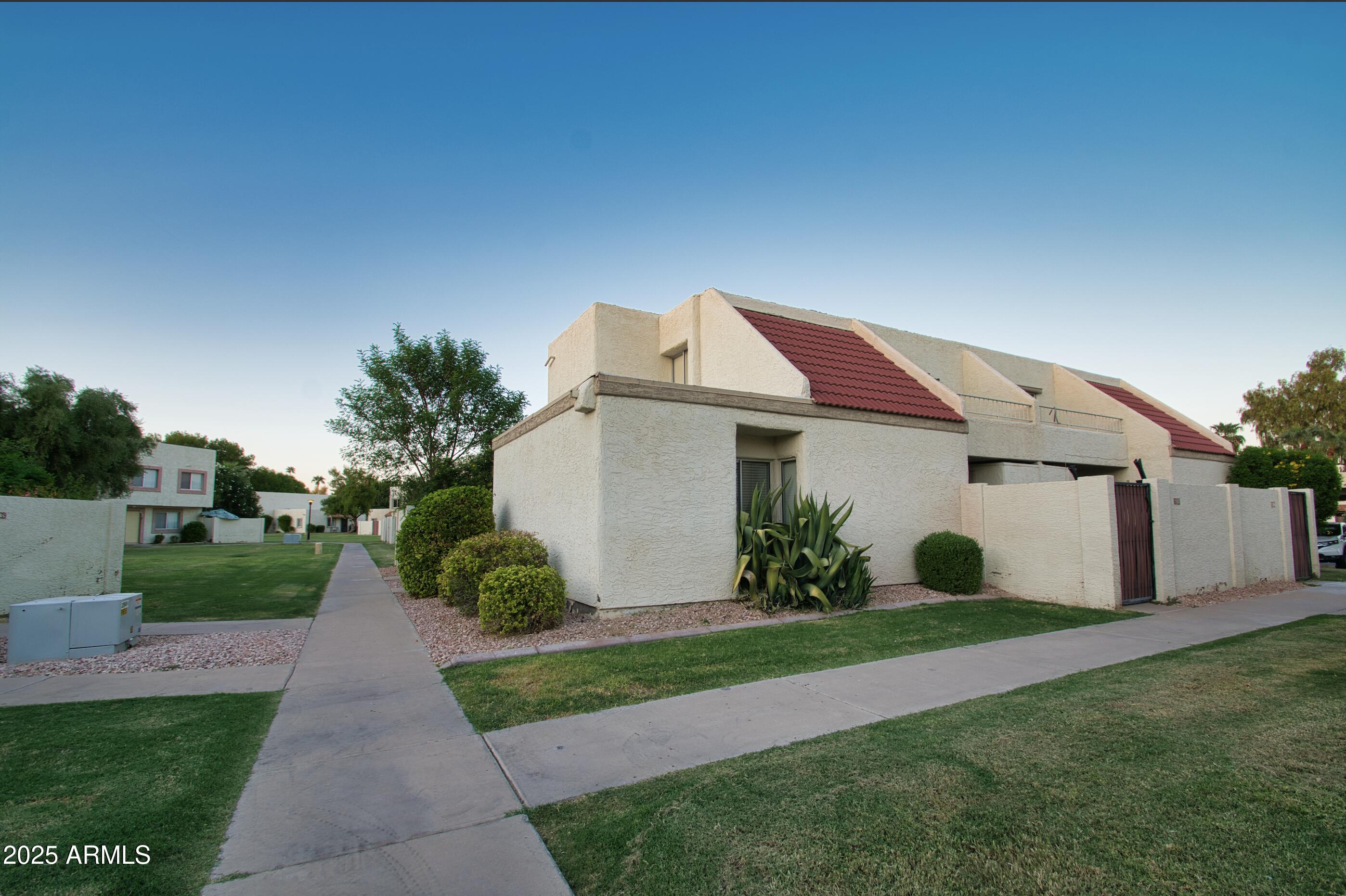 6018 North 79th Street Scottsdale, AZ 85250 - Photo 2 of 24 a front view of house with yard and green space