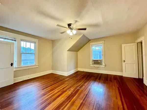 wooden floor in an empty room with a window