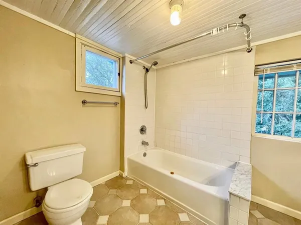 a bathroom with a toilet a sink and shower