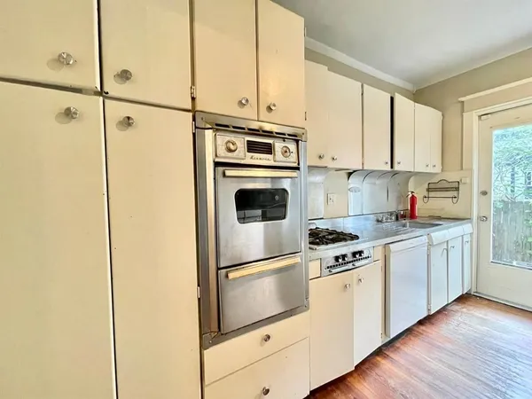 a kitchen with stainless steel appliances granite countertop cabinets and wooden floor