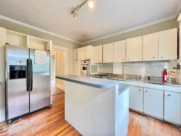 a kitchen with stainless steel appliances granite countertop a refrigerator sink and cabinets