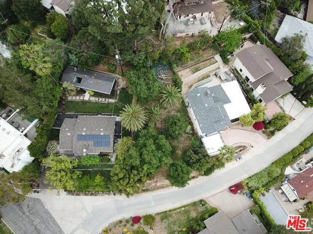 an aerial view of a house with a yard and garden