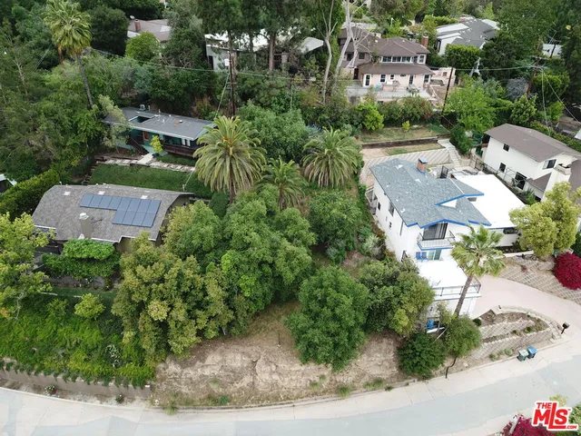 an aerial view of multiple houses with yard