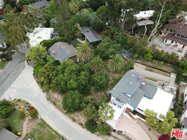 an aerial view of a house with outdoor space and street view