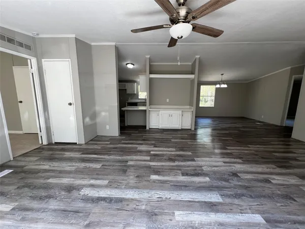 a view of empty room and kitchen