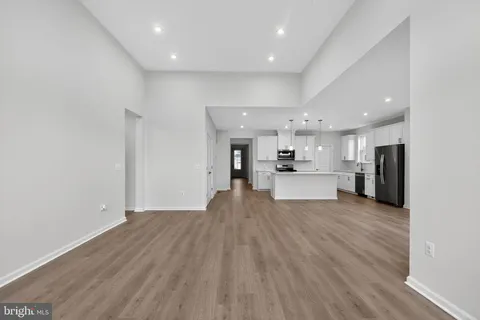 a view of kitchen with kitchen island and stainless steel appliances
