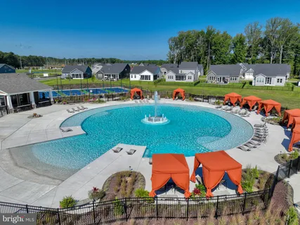 an aerial view of a house swimming pool and outdoor seating