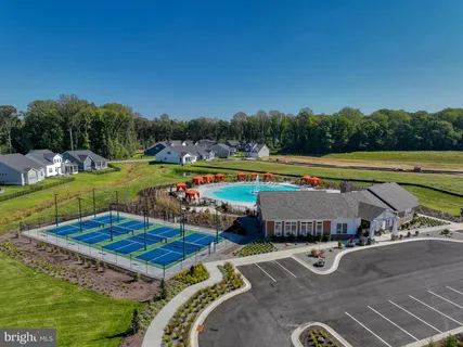 a view of a swimming pool and lounge chairs in the patio