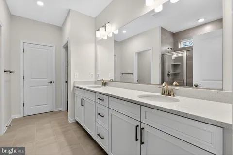 a bathroom with double sink and a mirror