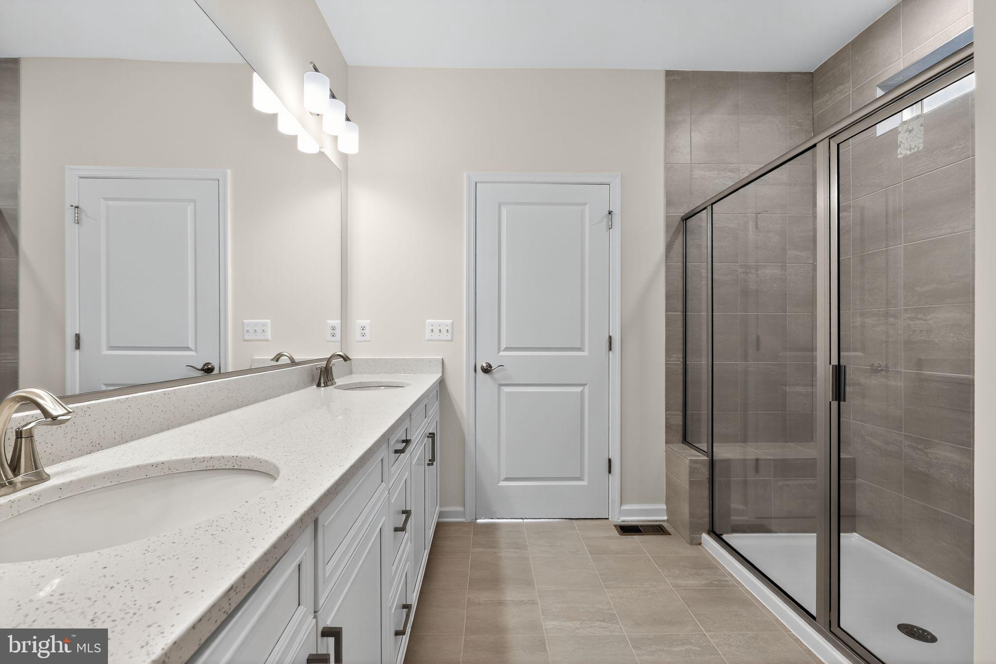 25020 Cypress Court Lewes, DE 19958 - Photo 5 of 21 a bathroom with a double vanity sink mirror and shower