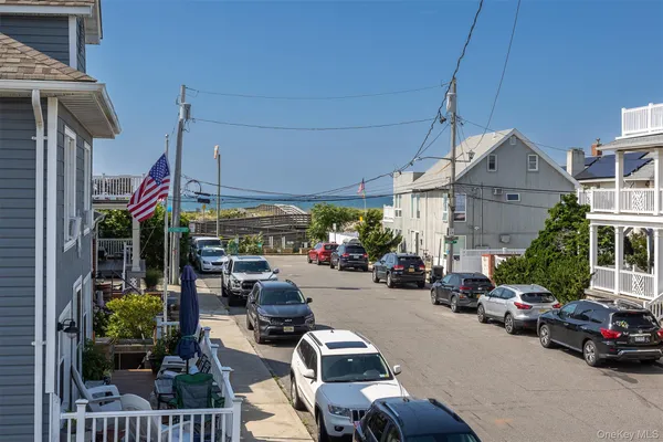 a view of a cars park in front of a building