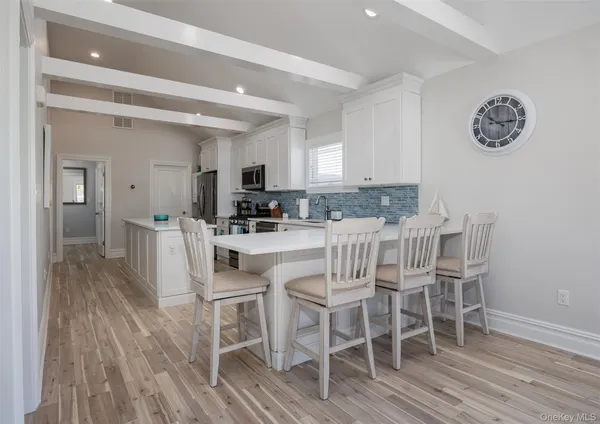 a dining room with furniture and wooden floor