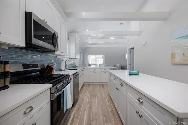 a kitchen with a sink stove and microwave