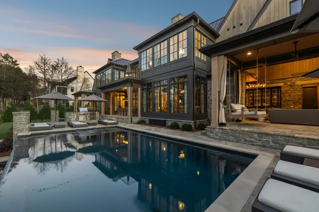a lobby room with fireplace furniture and floor to ceiling window