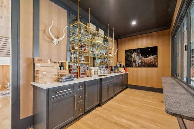 a living room with furniture a fireplace and a floor to ceiling window