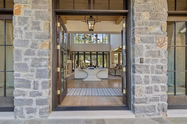 a large kitchen with stainless steel appliances kitchen island granite countertop a stove a sink and a refrigerator