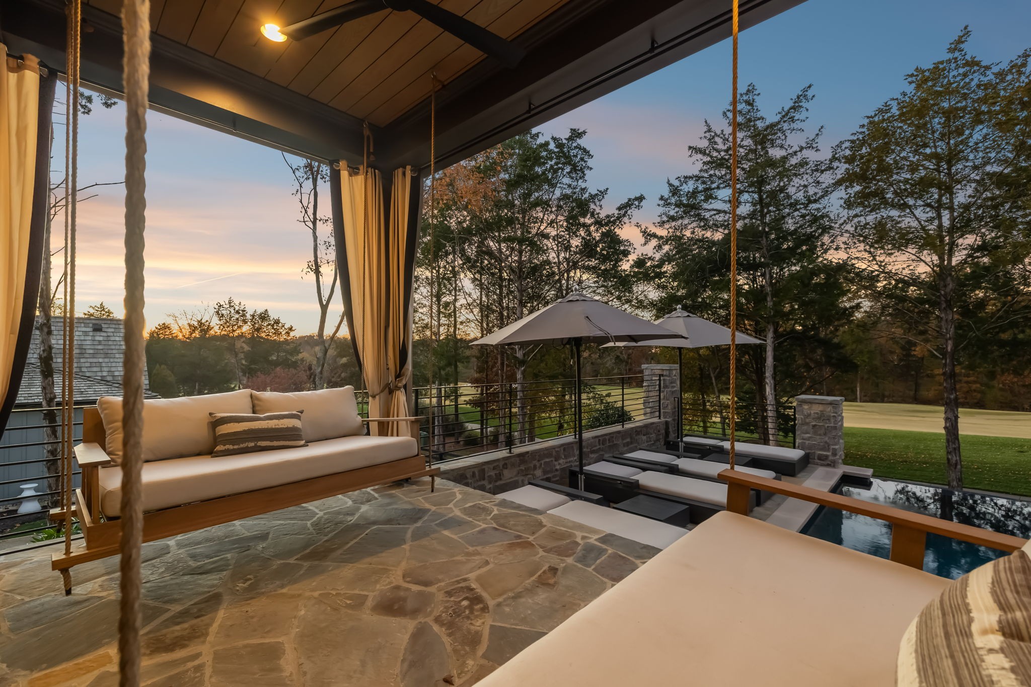 7573 Whiskey Road College Grove, TN 37046 - Photo 87 of 100 a view of a patio with couches table and chairs under an umbrella with a small yard