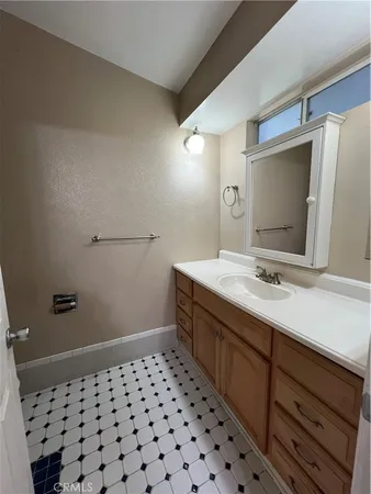 a bathroom with a double vanity sink and mirror