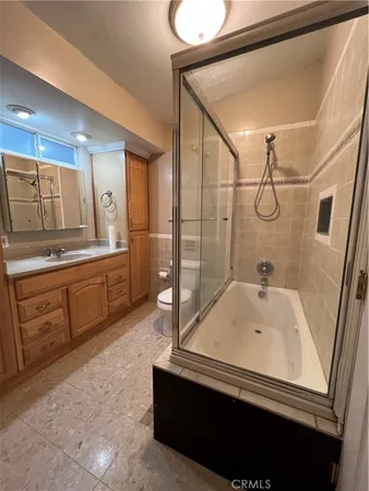 a bathroom with a tub sink and mirror