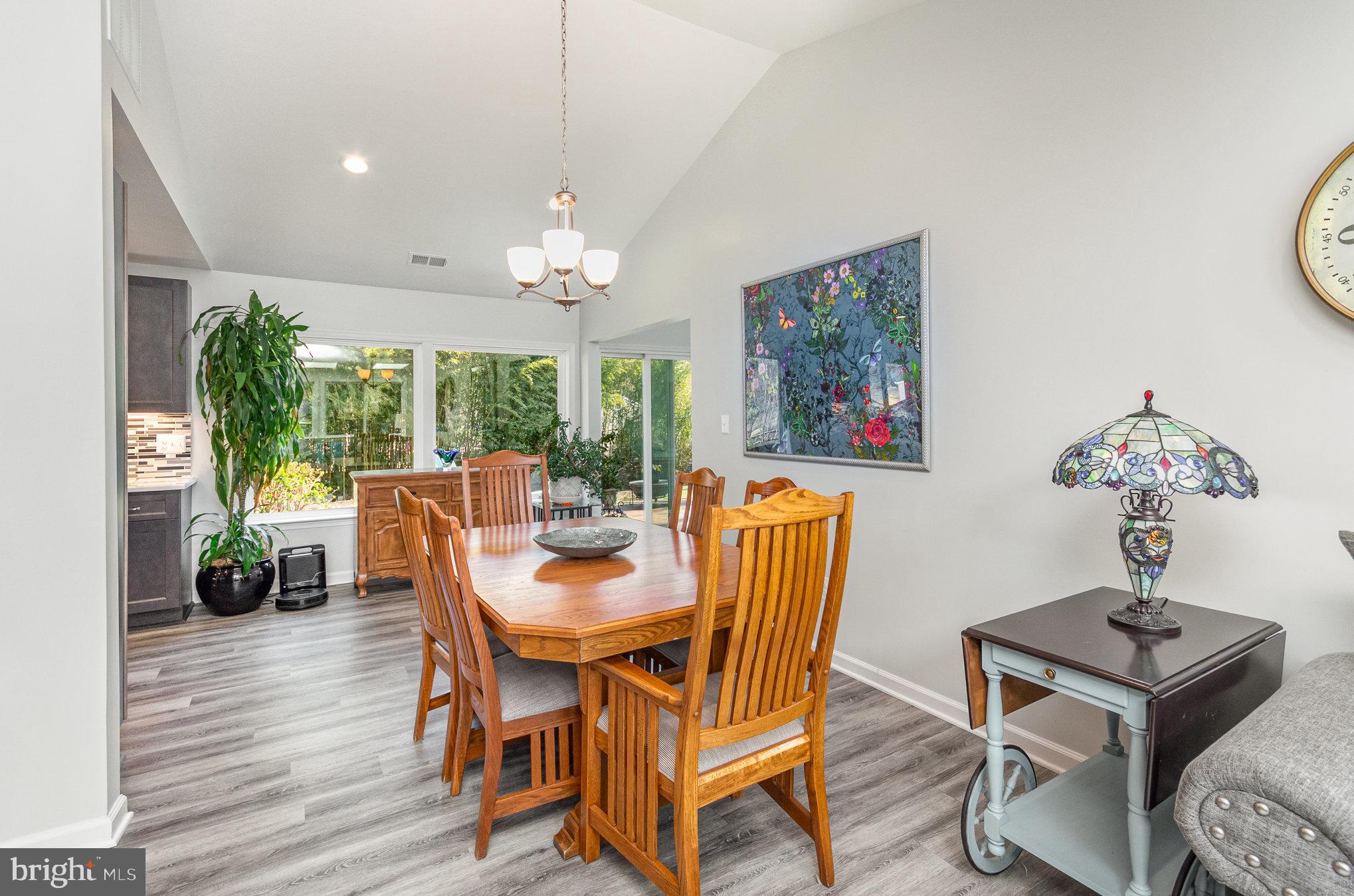 6932 Spelman Drive Springfield, VA 22153 - Photo 11 of 37 a dining room with furniture a window and a chandelier
