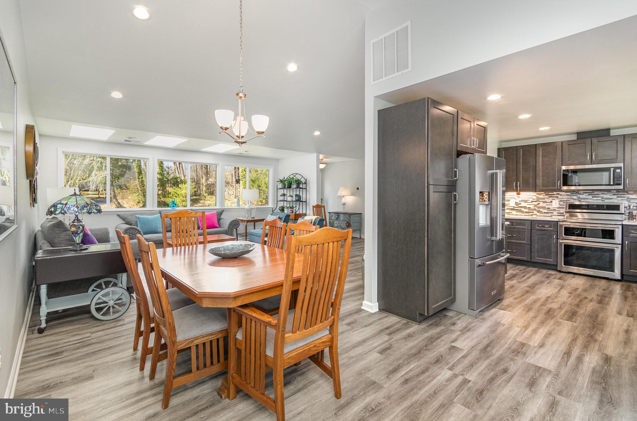 6932 Spelman Drive Springfield, VA 22153 - Photo 13 of 37 a view of a dining room with furniture large window and stainless steel appliances