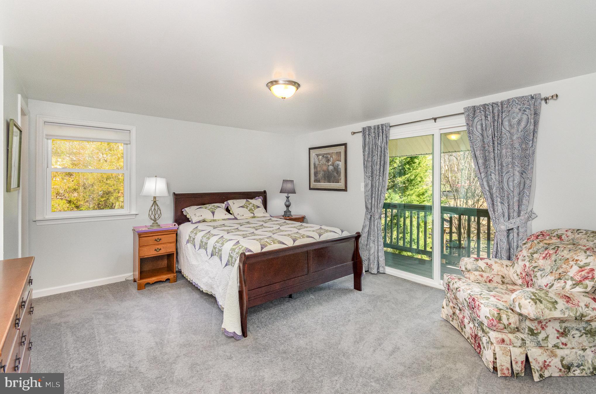 6932 Spelman Drive Springfield, VA 22153 - Photo 17 of 37 a bed sitting in a bedroom next to a window