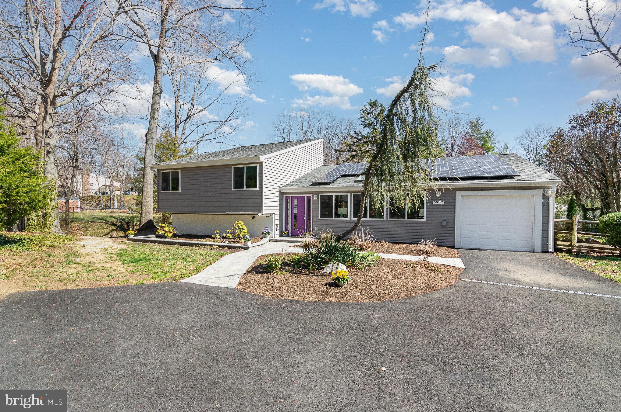 6932 Spelman Drive Springfield, VA 22153 - Photo 2 of 37 a front view of a house with a yard and garage