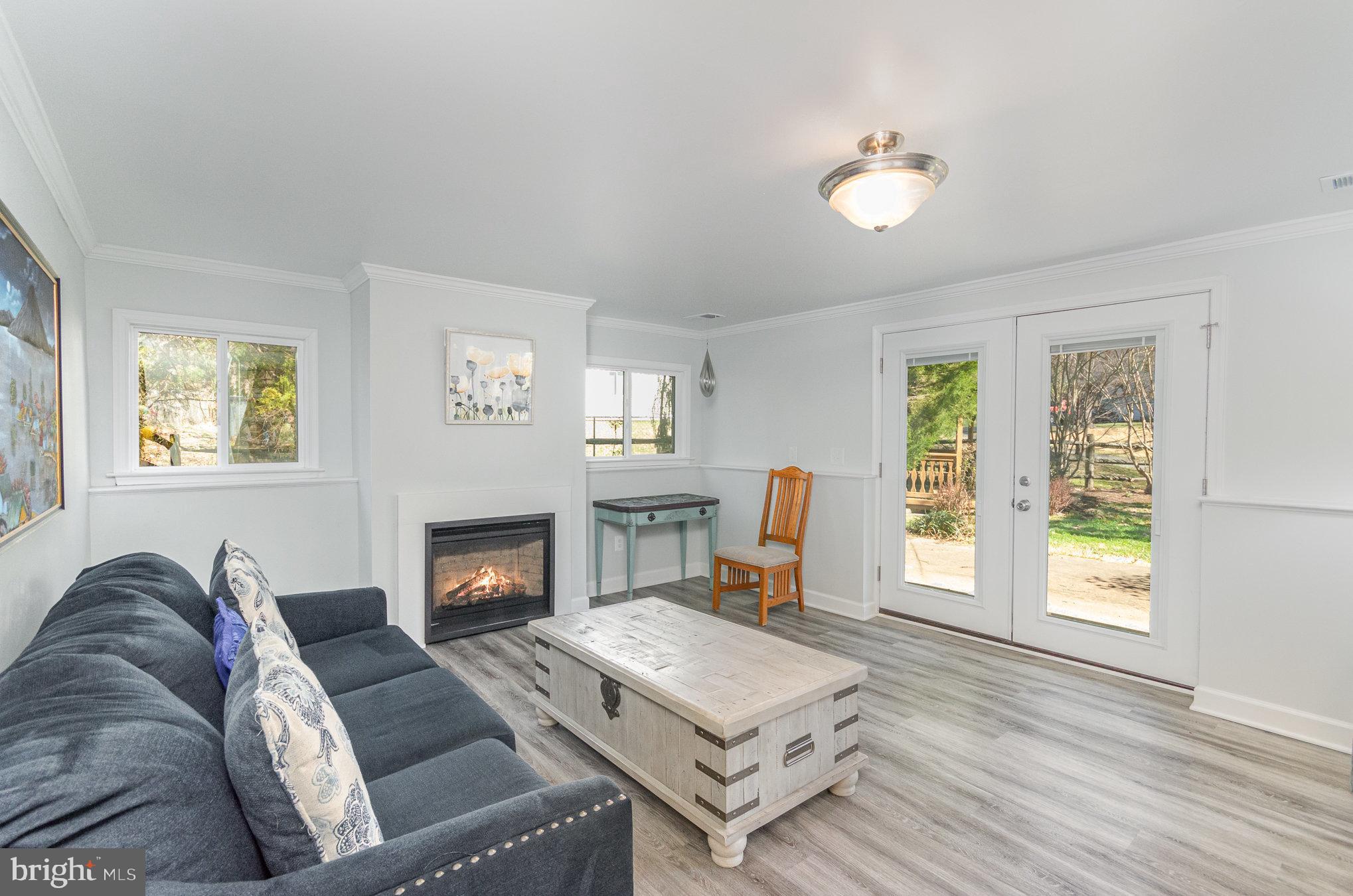 6932 Spelman Drive Springfield, VA 22153 - Photo 23 of 37 a living room with furniture and a fireplace