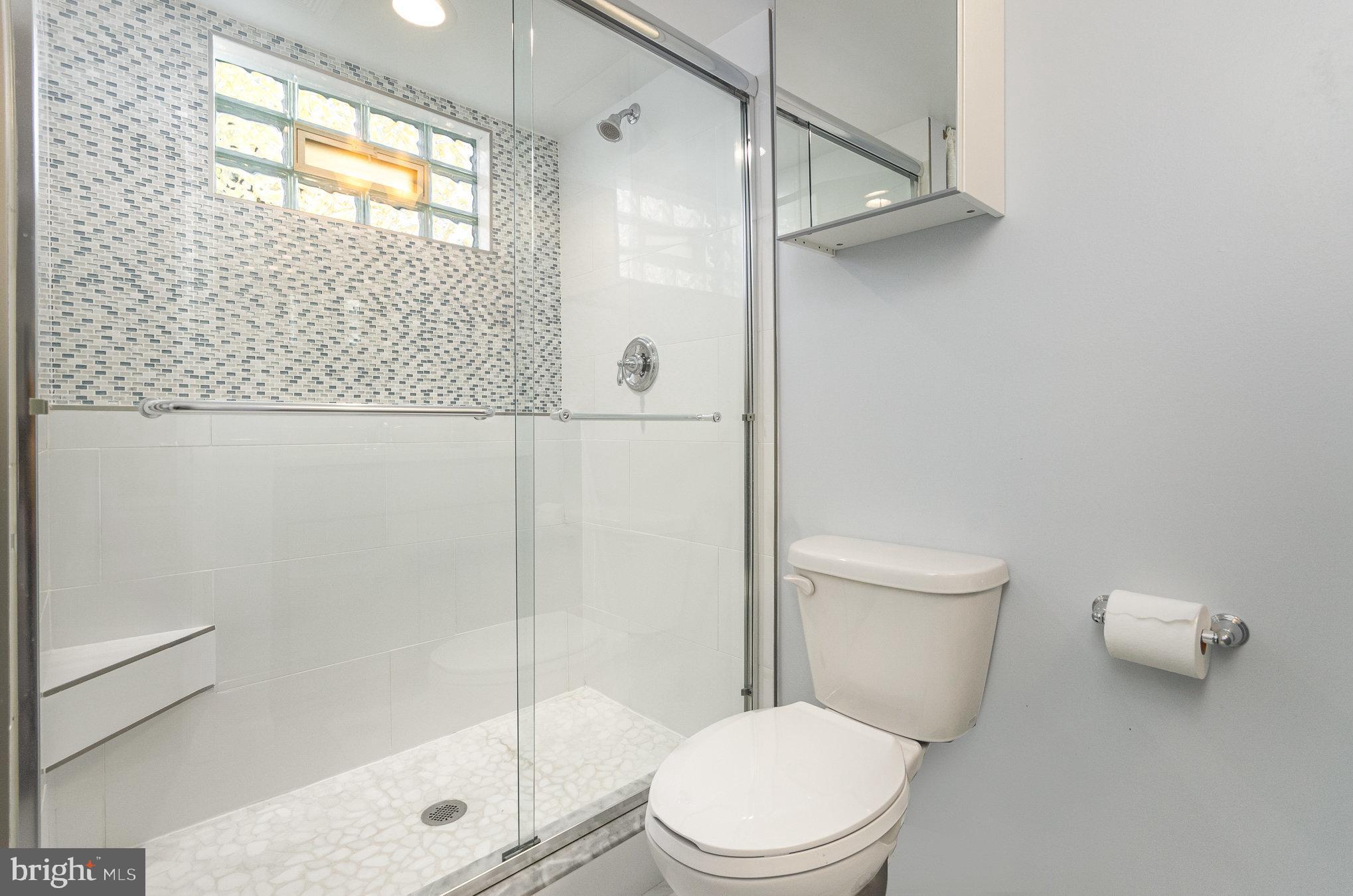 6932 Spelman Drive Springfield, VA 22153 - Photo 27 of 37 a white toilet sitting next to a shower