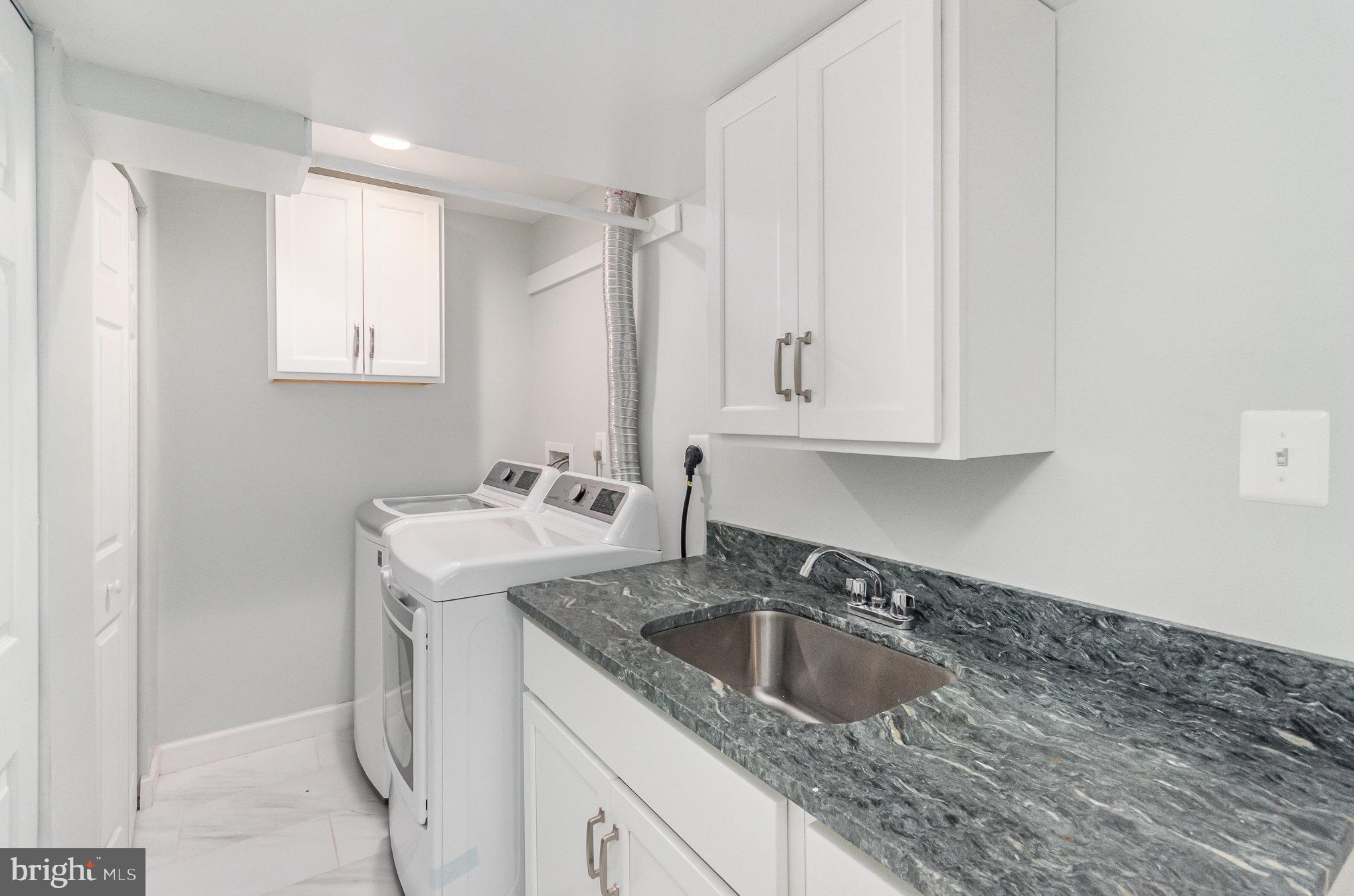 6932 Spelman Drive Springfield, VA 22153 - Photo 28 of 37 a kitchen with granite countertop a sink stove and cabinets
