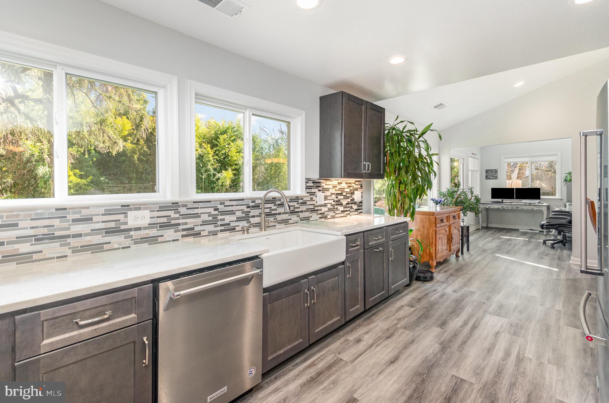 6932 Spelman Drive Springfield, VA 22153 - Photo 5 of 37 a kitchen with stainless steel appliances kitchen island granite countertop a stove a sink and a refrigerator