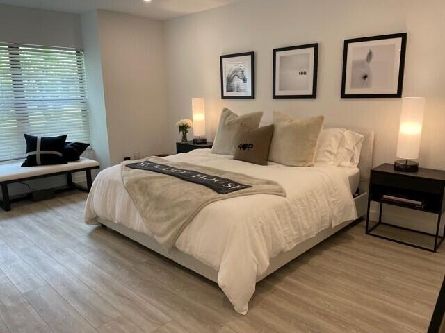 13400 Polo Road West Wellington, FL 33414 - Photo 11 of 16 a bedroom with a bed and wooden floor