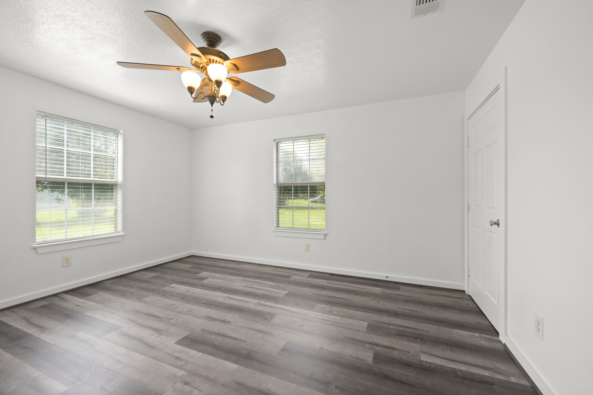 1935 1st Street Hempstead, TX 77445 - Photo 24 of 29 a view of an empty room with wooden floor and a window
