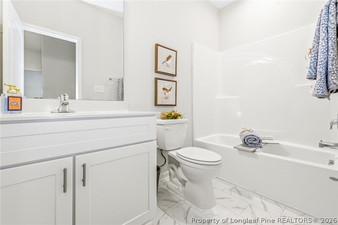 5421 Short Leaf (lot 109) Road Raeford, NC 28376 - Photo 12 of 29 a bathroom with a sink toilet and a mirror