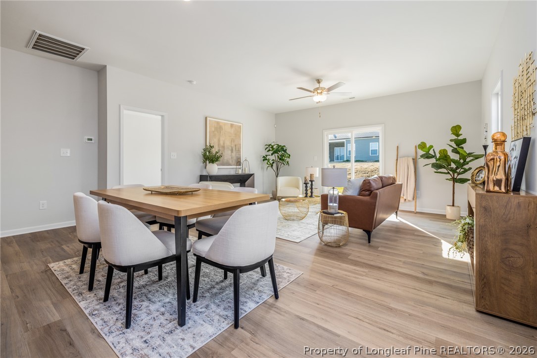 5421 Short Leaf (lot 109) Road Raeford, NC 28376 - Photo 17 of 29 a view of a dining room with furniture and wooden floor