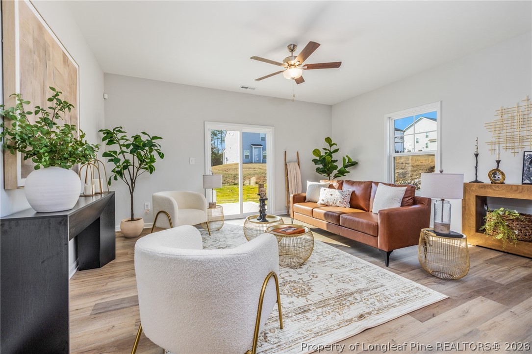 5421 Short Leaf (lot 109) Road Raeford, NC 28376 - Photo 19 of 29 a living room with furniture and a chandelier