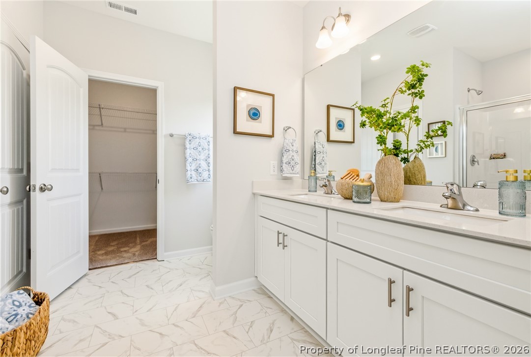 5421 Short Leaf (lot 109) Road Raeford, NC 28376 - Photo 25 of 29 a bathroom with a sink a mirror and a shower