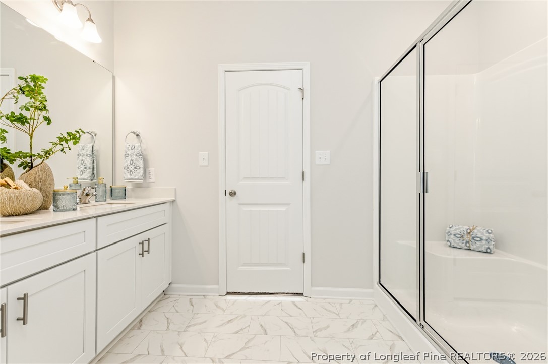 5421 Short Leaf (lot 109) Road Raeford, NC 28376 - Photo 26 of 29 a bathroom with a granite countertop sink a mirror and a shower