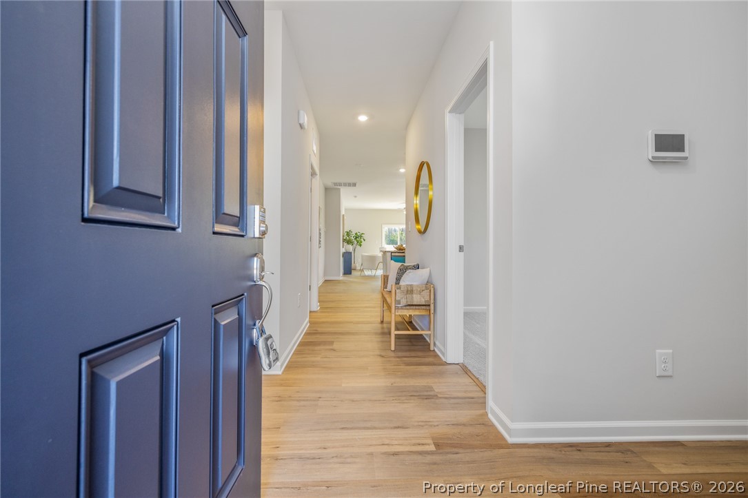 5421 Short Leaf (lot 109) Road Raeford, NC 28376 - Photo 4 of 29 a view of a hallway with wooden floor and staircase