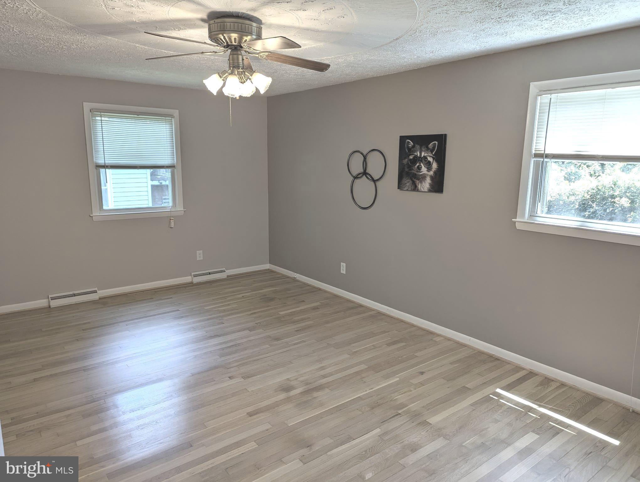 1712 Forestville Road Edgewater, MD 21037 - Photo 10 of 31 wooden floor in an empty room with a window