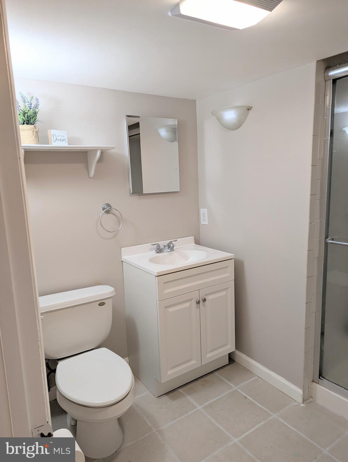 1712 Forestville Road Edgewater, MD 21037 - Photo 16 of 31 a bathroom with a toilet sink and mirror