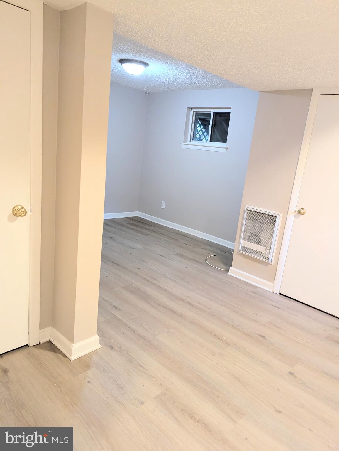 1712 Forestville Road Edgewater, MD 21037 - Photo 19 of 31 a view of an empty room with wooden floor and a window