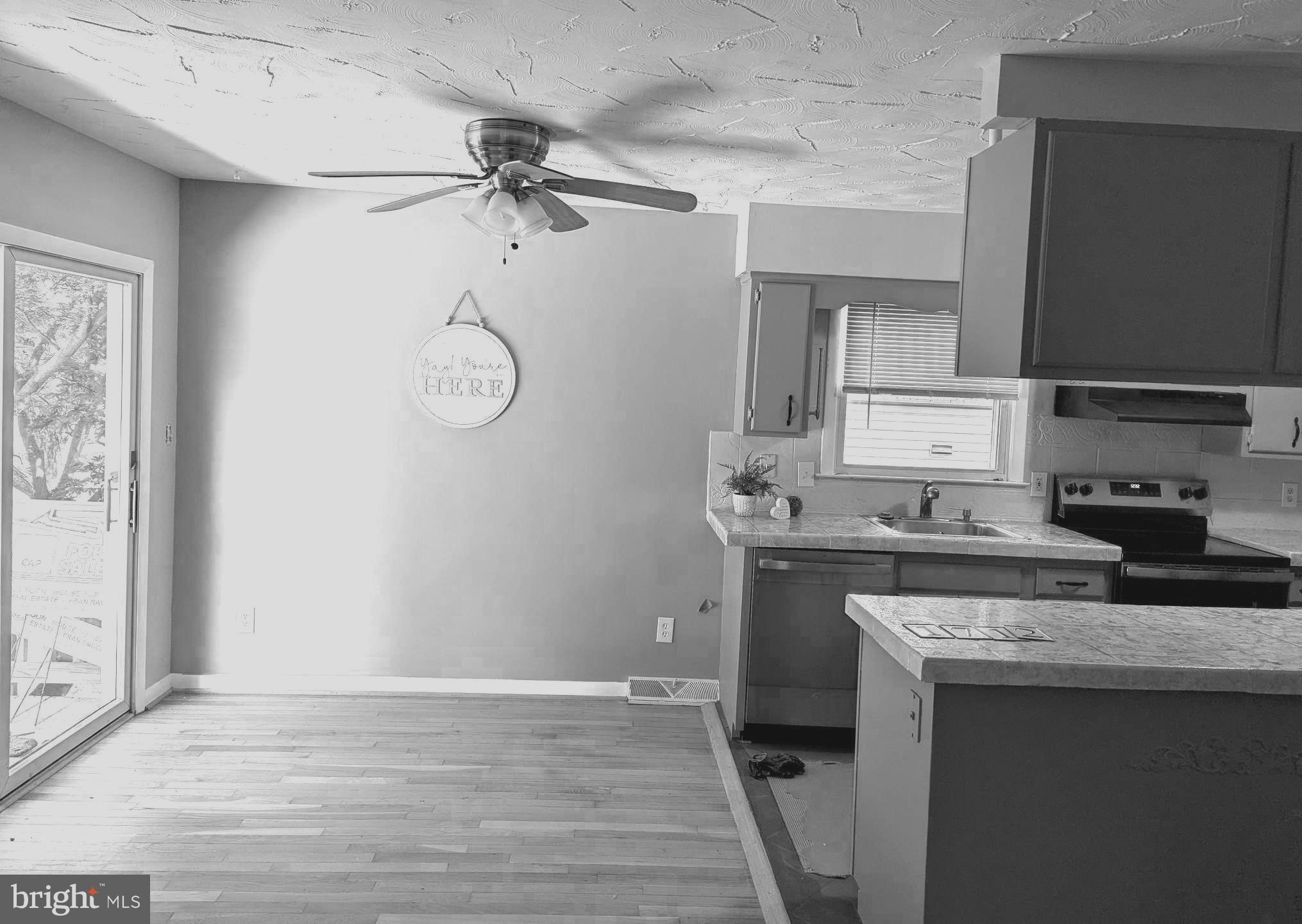 1712 Forestville Road Edgewater, MD 21037 - Photo 6 of 31 a kitchen with a sink cabinets and wooden floor