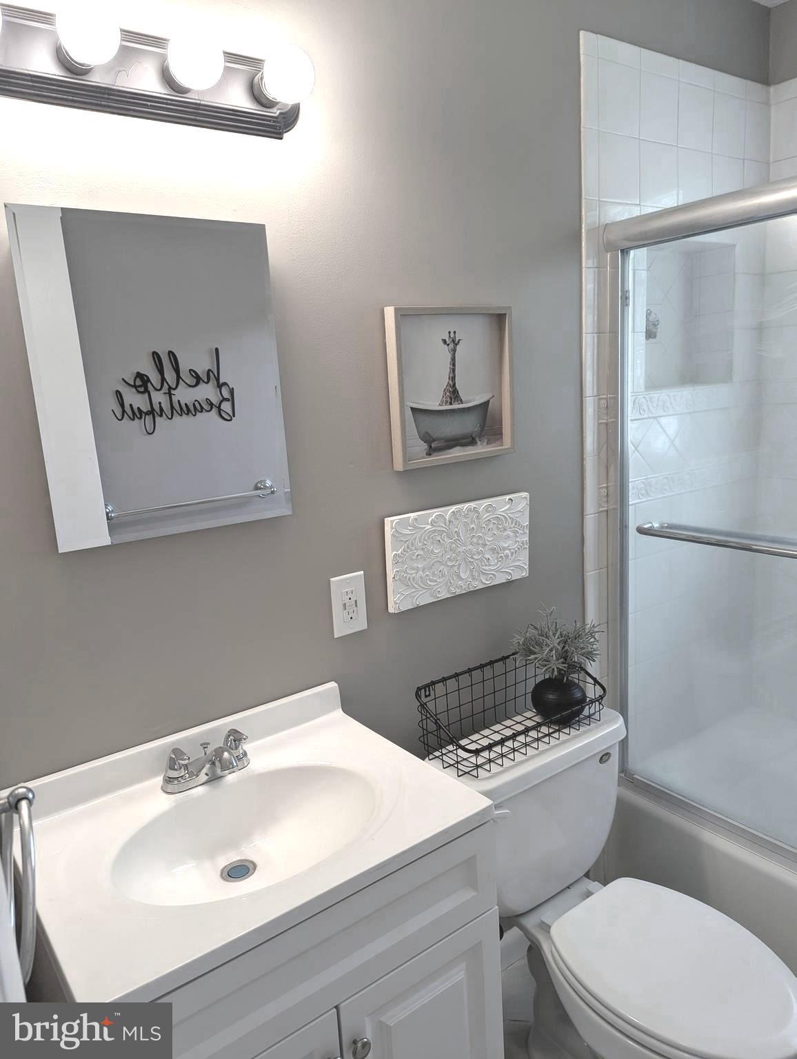 1712 Forestville Road Edgewater, MD 21037 - Photo 7 of 31 a bathroom with a sink a toilet and a mirror