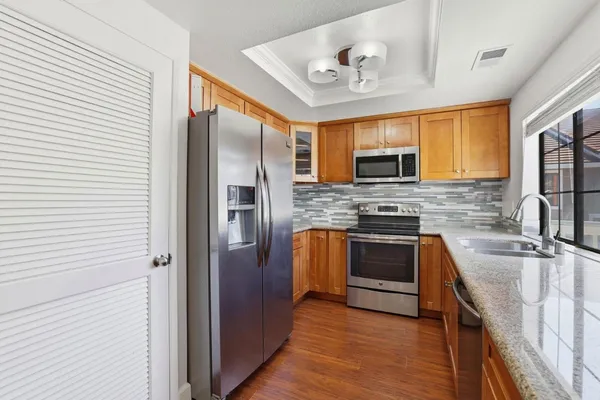 a kitchen with stainless steel appliances granite countertop a stove top oven a sink and dishwasher
