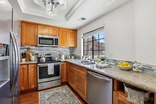 a kitchen with a sink stove and microwave