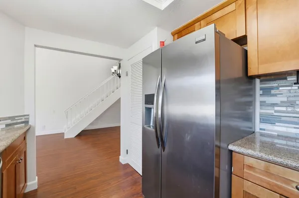 a kitchen with stainless steel appliances granite countertop a refrigerator and a sink