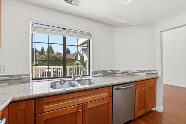 a kitchen with granite countertop a sink and a window