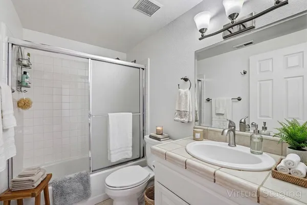 a bathroom with a toilet a sink and a shower