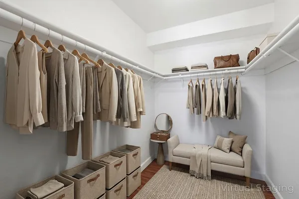 a living room with furniture a ceiling fan and a wooden floor